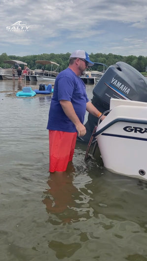 Boater using the Sand Saber 4FT shallow water anchor pole to secure a boat in shallow water at a sandbar
